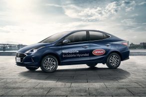 carro hb20s sedan na cor azul marinho estampado com as palavras transporte solidario hyundai e logo do grupo concessionario geracao