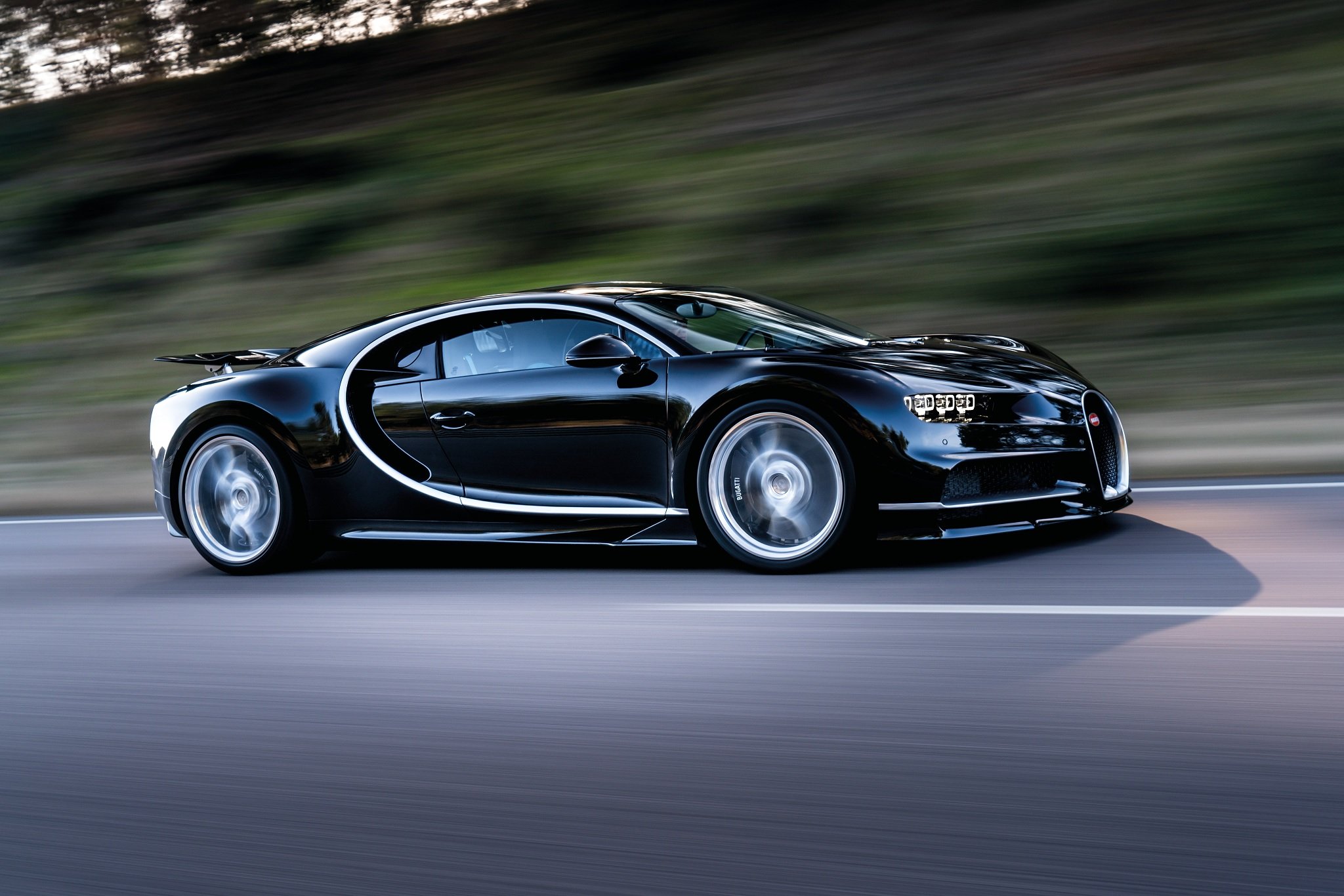 bugatti chiron preto em alta velocidade visto pela lateral