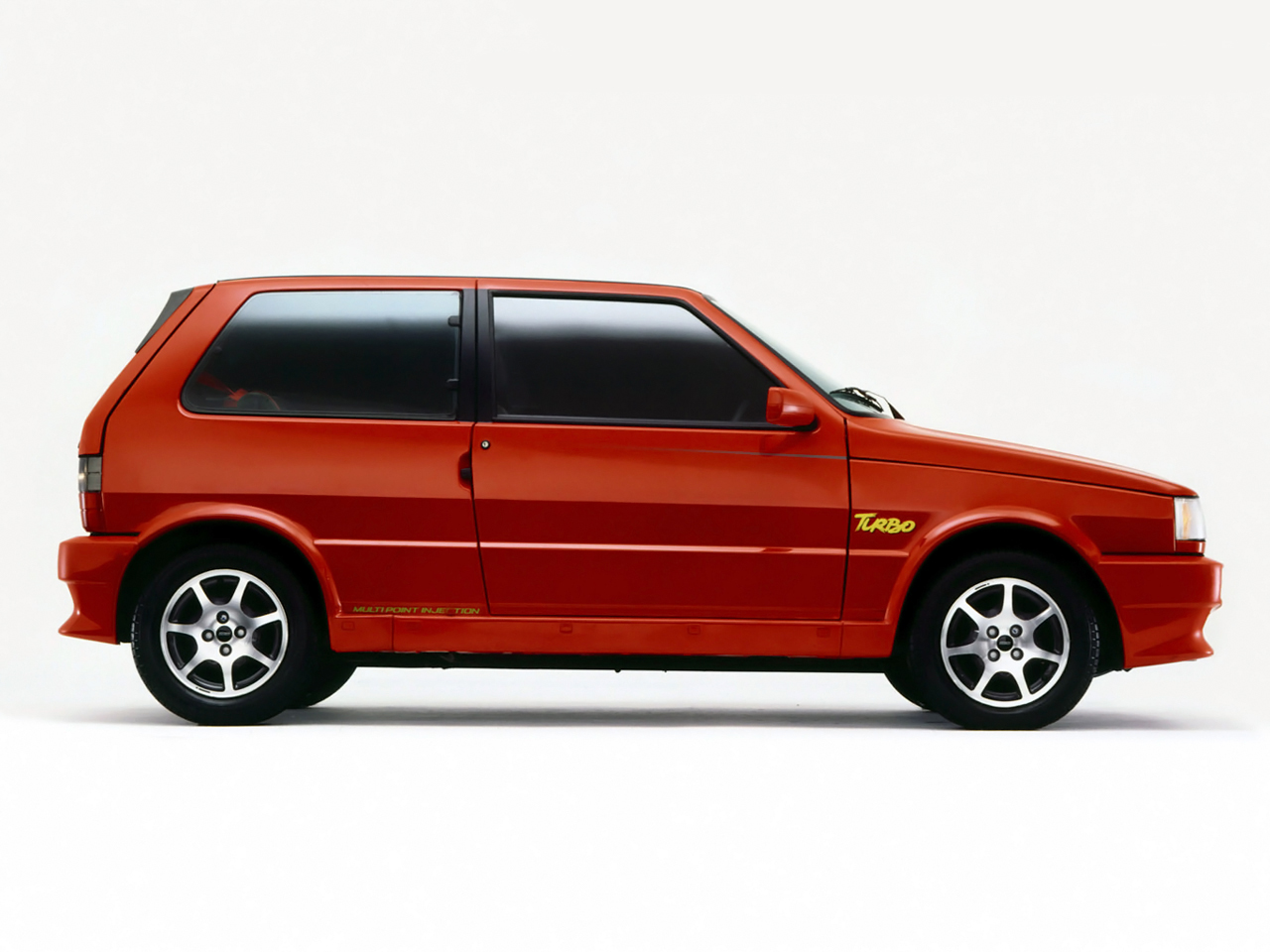 fiat uno turbo i e 1994 vermelho lateral parado