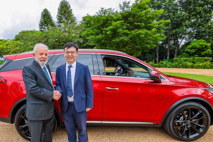 byd tan ev vermelho lateral com presidente luis inacio lula da silva e tyler li apertando maos