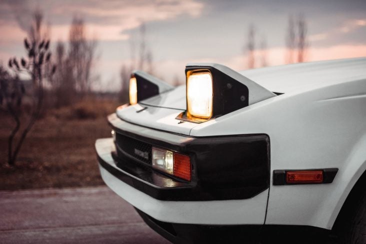White,Old,Japanese,1980s,Car,With,Pop up,Headlights ,Blurry,Countryside