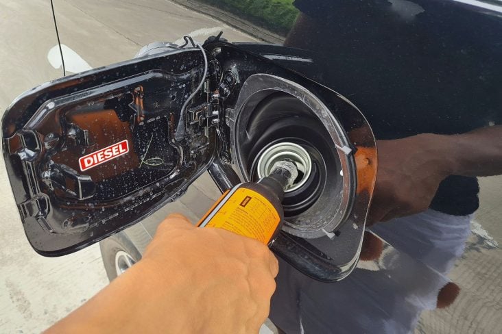 A,Driver,Fills,A,Diesel,Additive,Into,A,Car's,Diesel