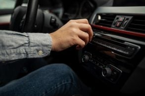 Hand,Pressing,A,Button,Of,A,Car,Audio,System