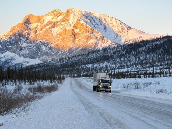 A truck passes Sukakpak Mountain on the Dalton Highway, Alaska