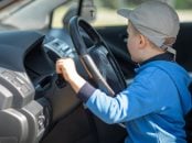 Little,Boy,Playing,With,A,Steering,Wheel,And,Turn,Switcher