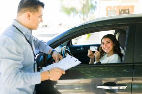 Portrait,Of,A,Cheerful,Teen,Girl,Showing,Her,Driver's,License