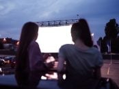 Rear,View,Of,Two,Female,Friends,Sitting,In,The,Car