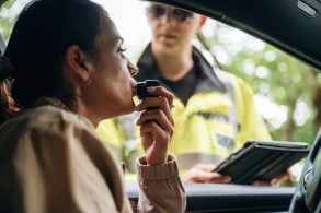 Woman,In,A,Beige,Jacket,Tests,Breath,Alcohol,Level,With